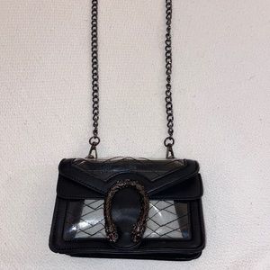 Clear and black leather bag with snake detail